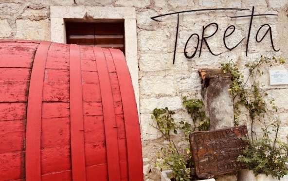 Painted red wine barrel at entrance to Toreta Winery showroom in Korcula, Croatia